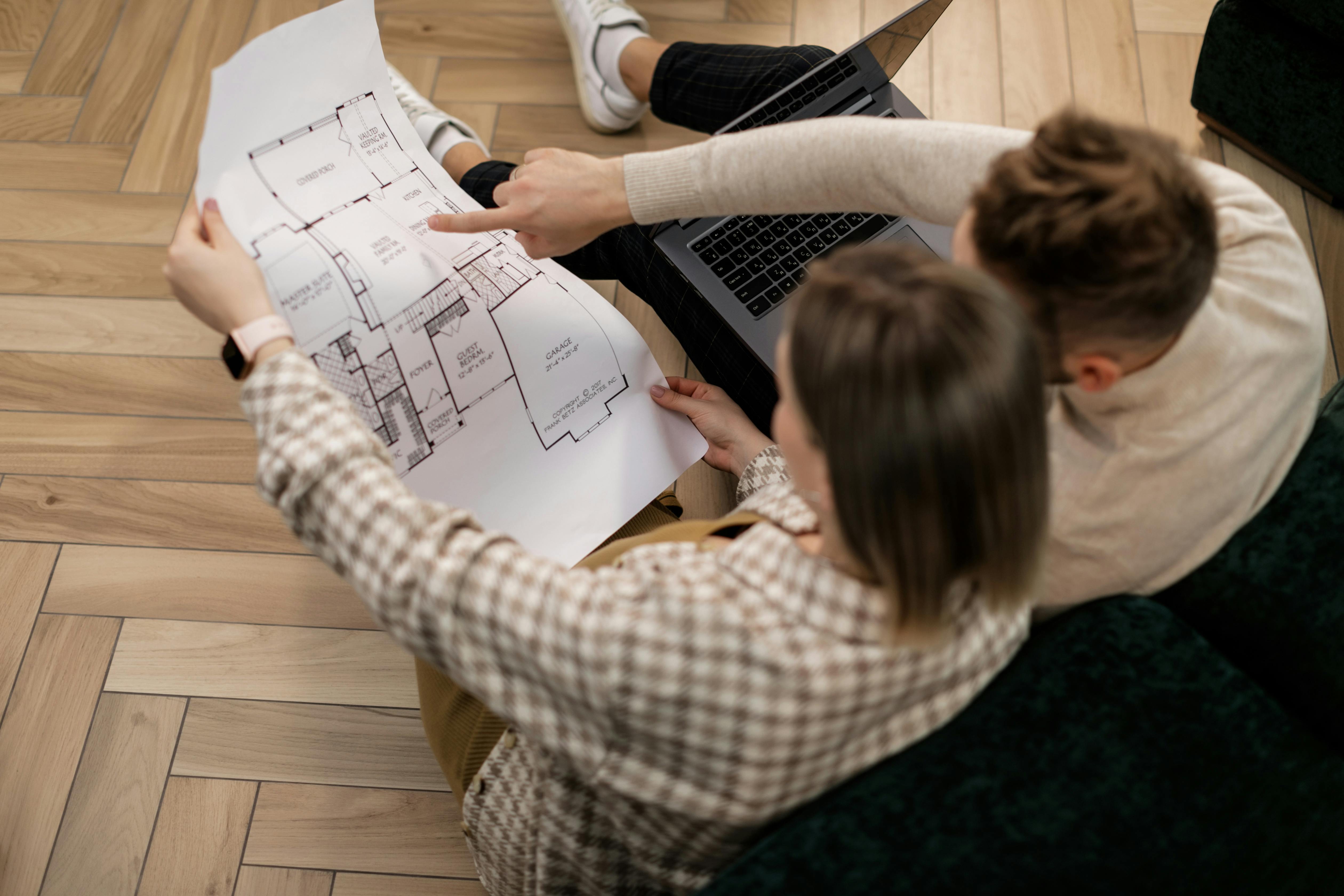 Couple examining house blueprint