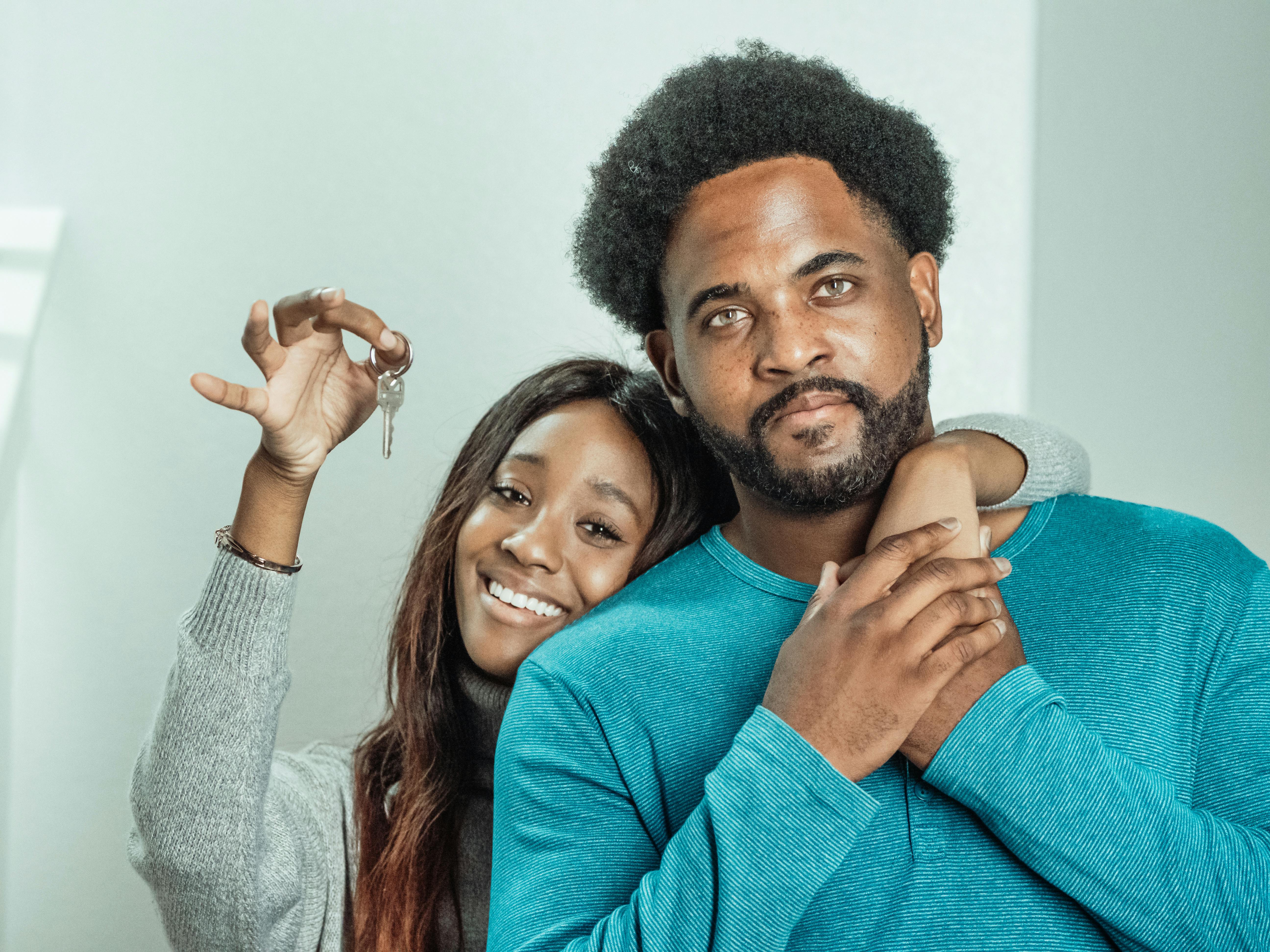 Couple receiving keys indoors