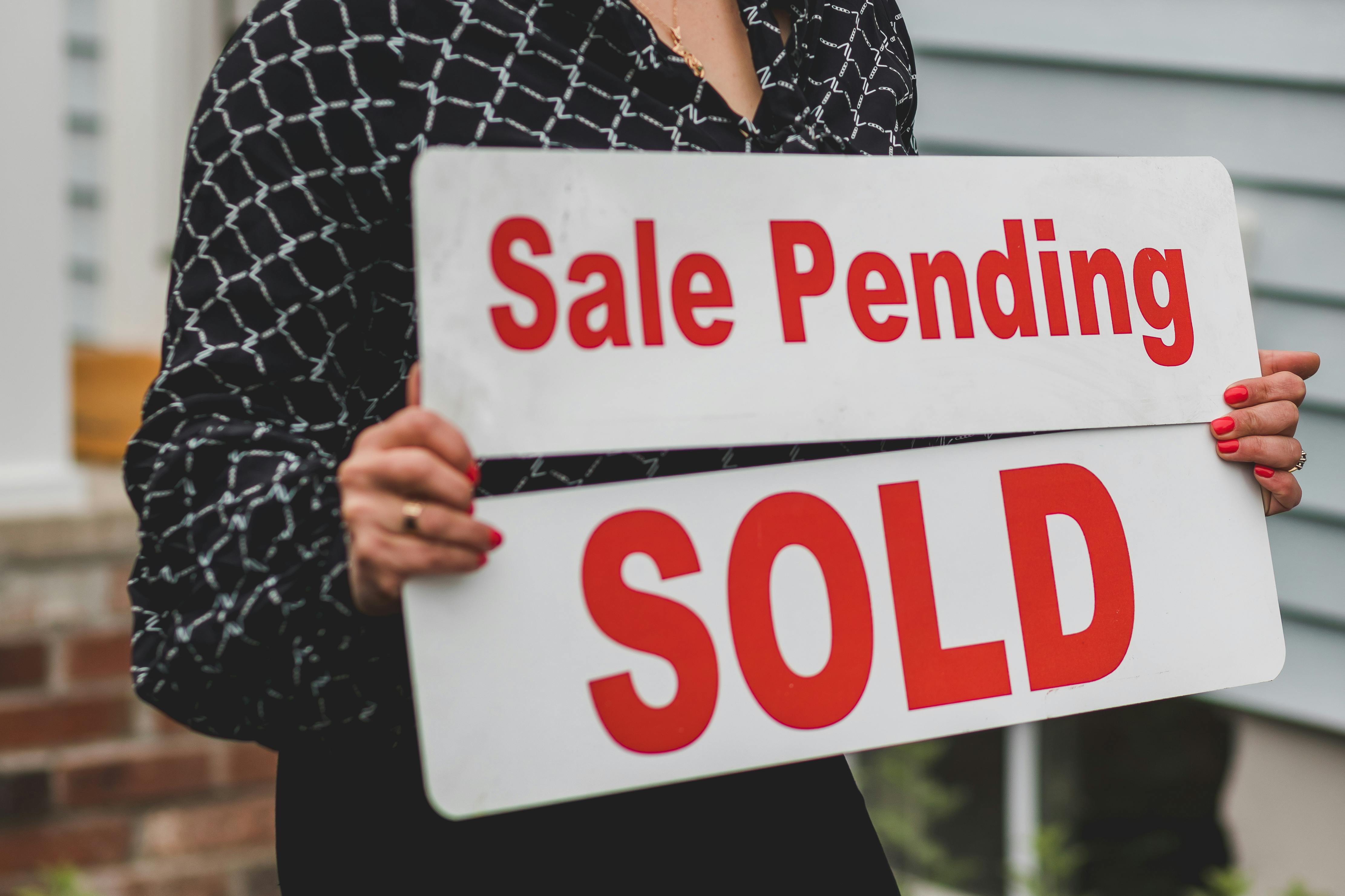 Businesswoman with Sale Signs