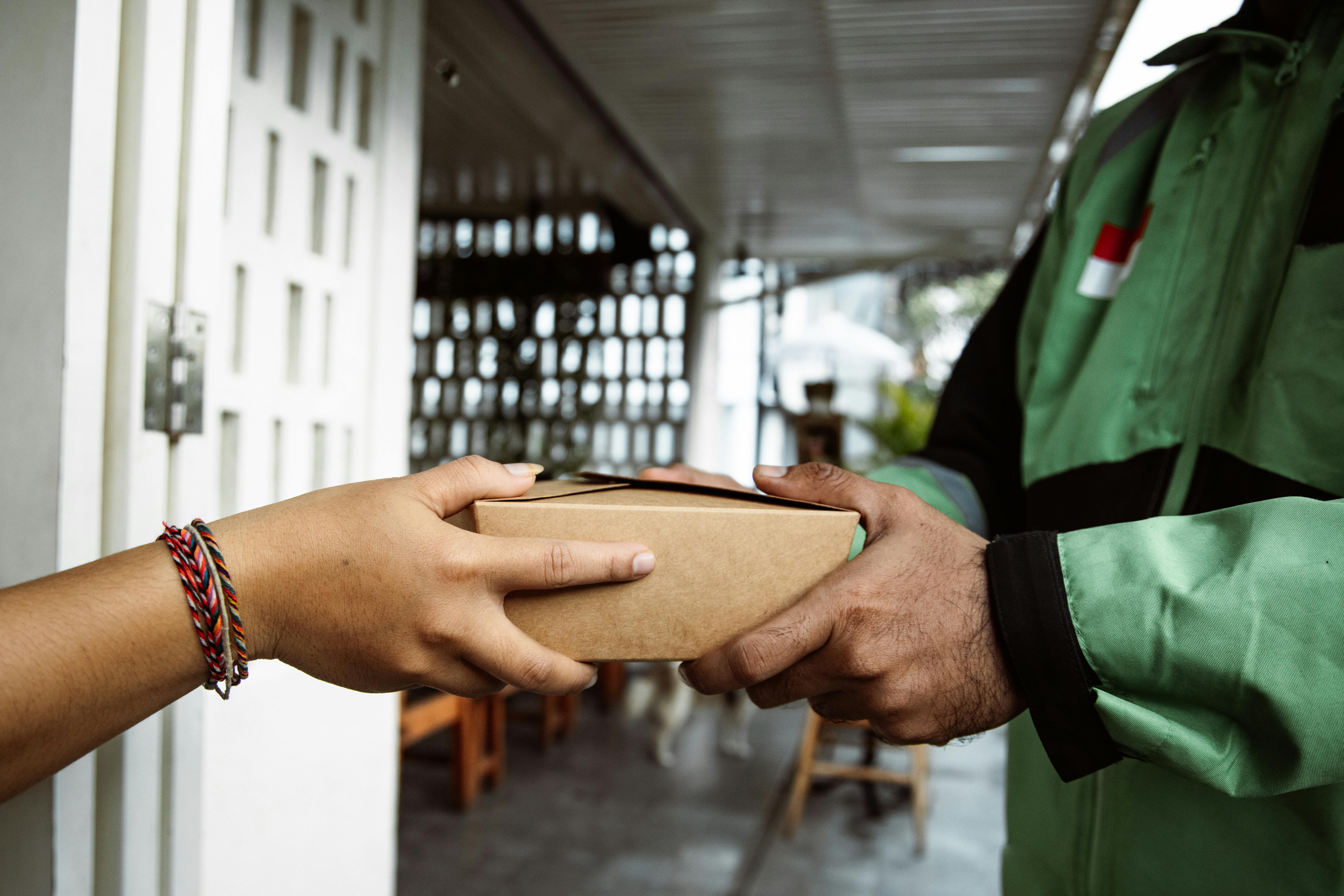 Delivery person hands over a package