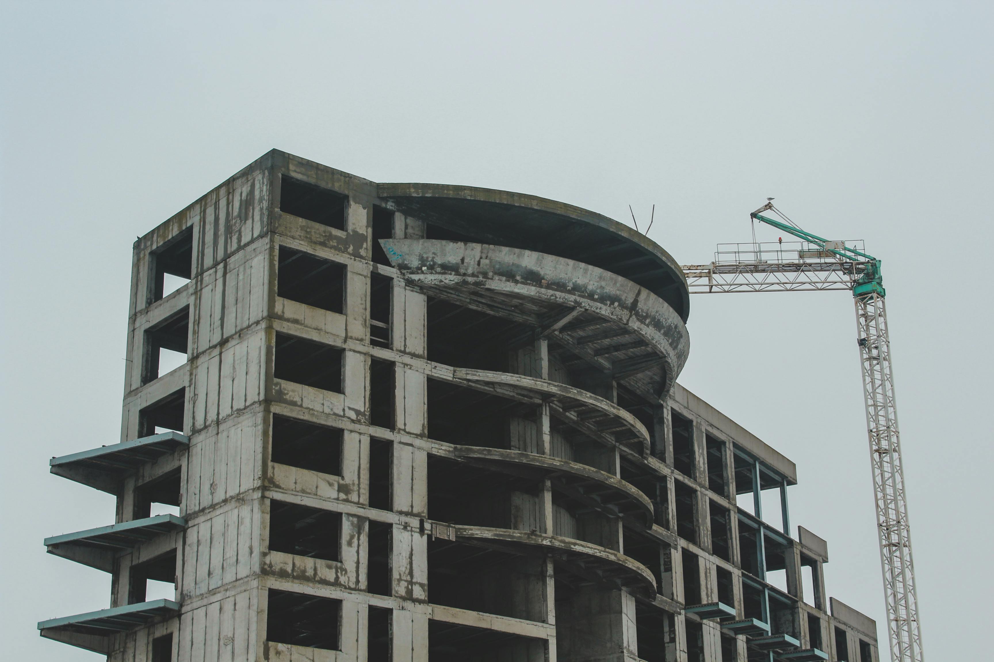 A high-rise building under construction with a crane