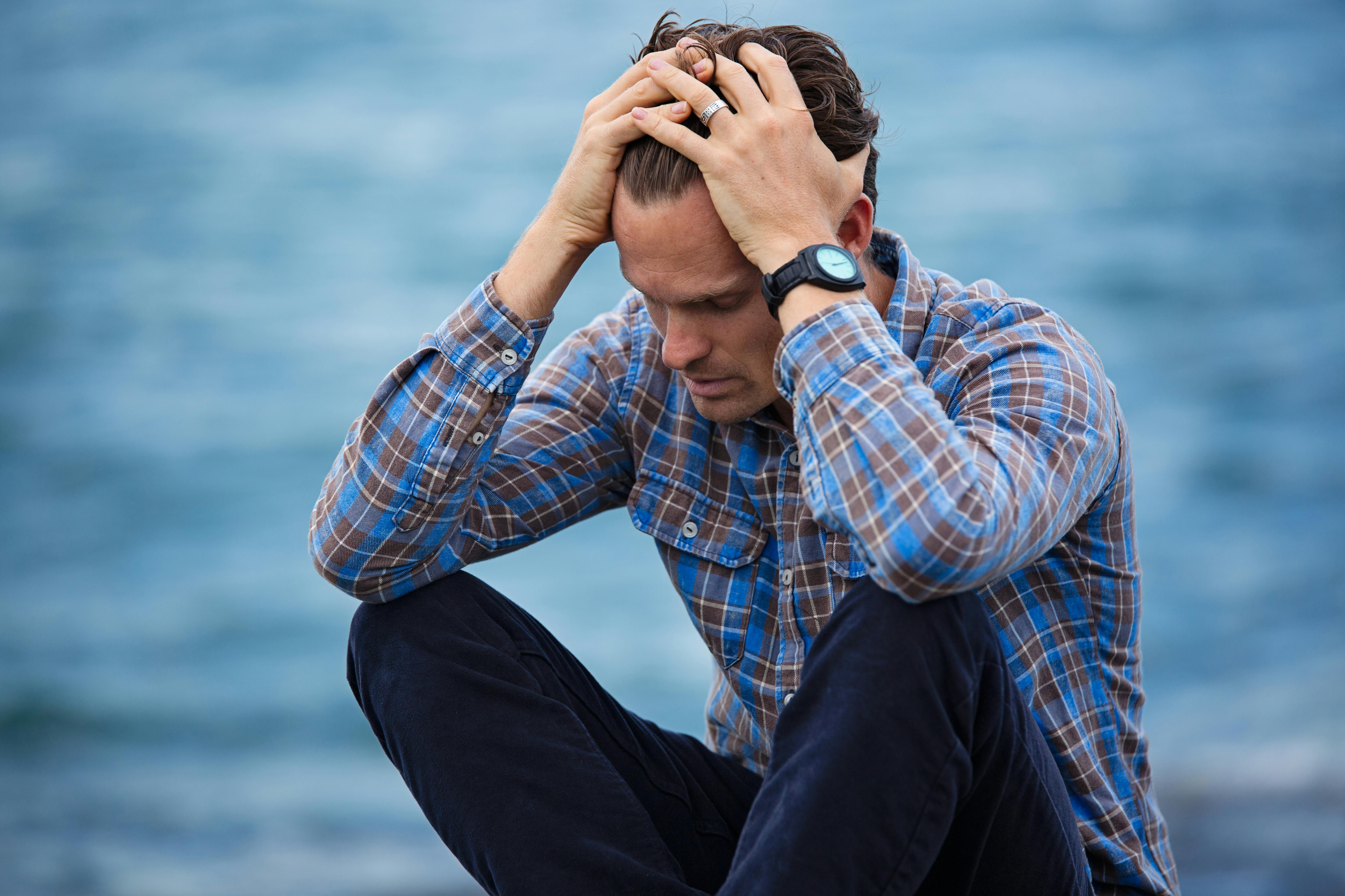 Man sitting by water