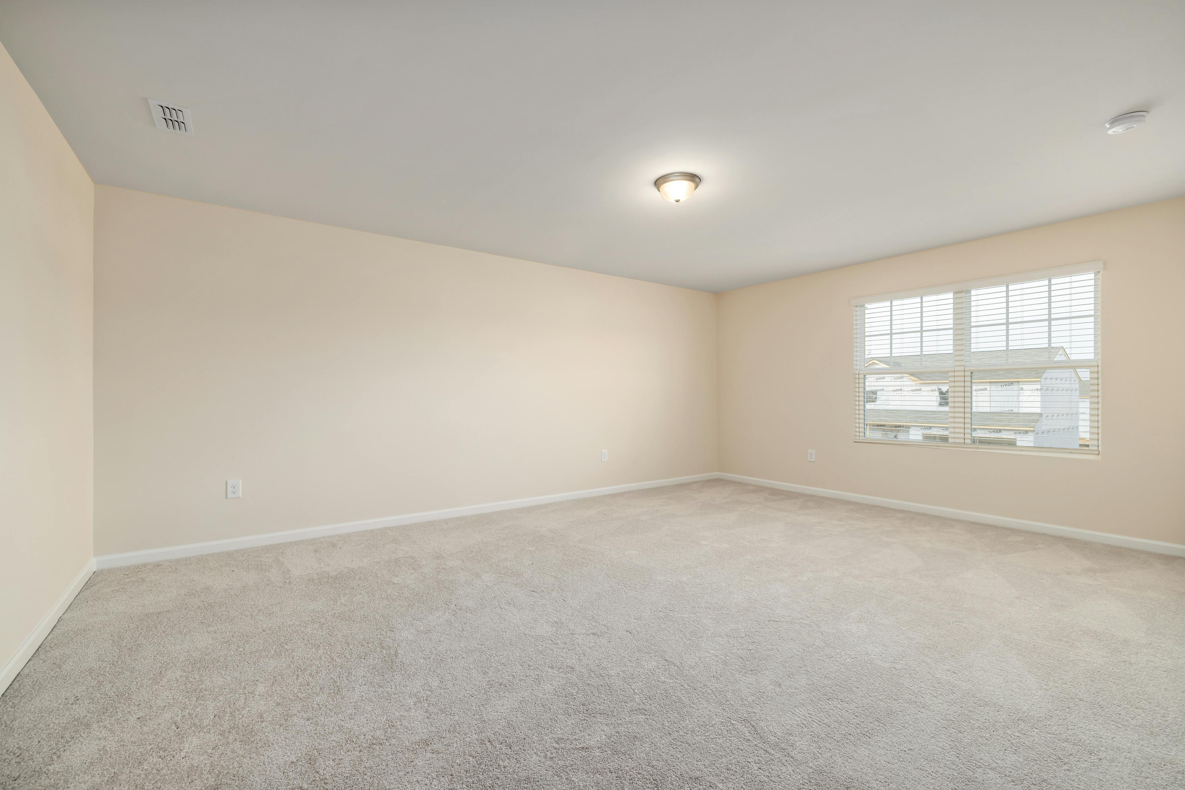 An empty room with beige walls