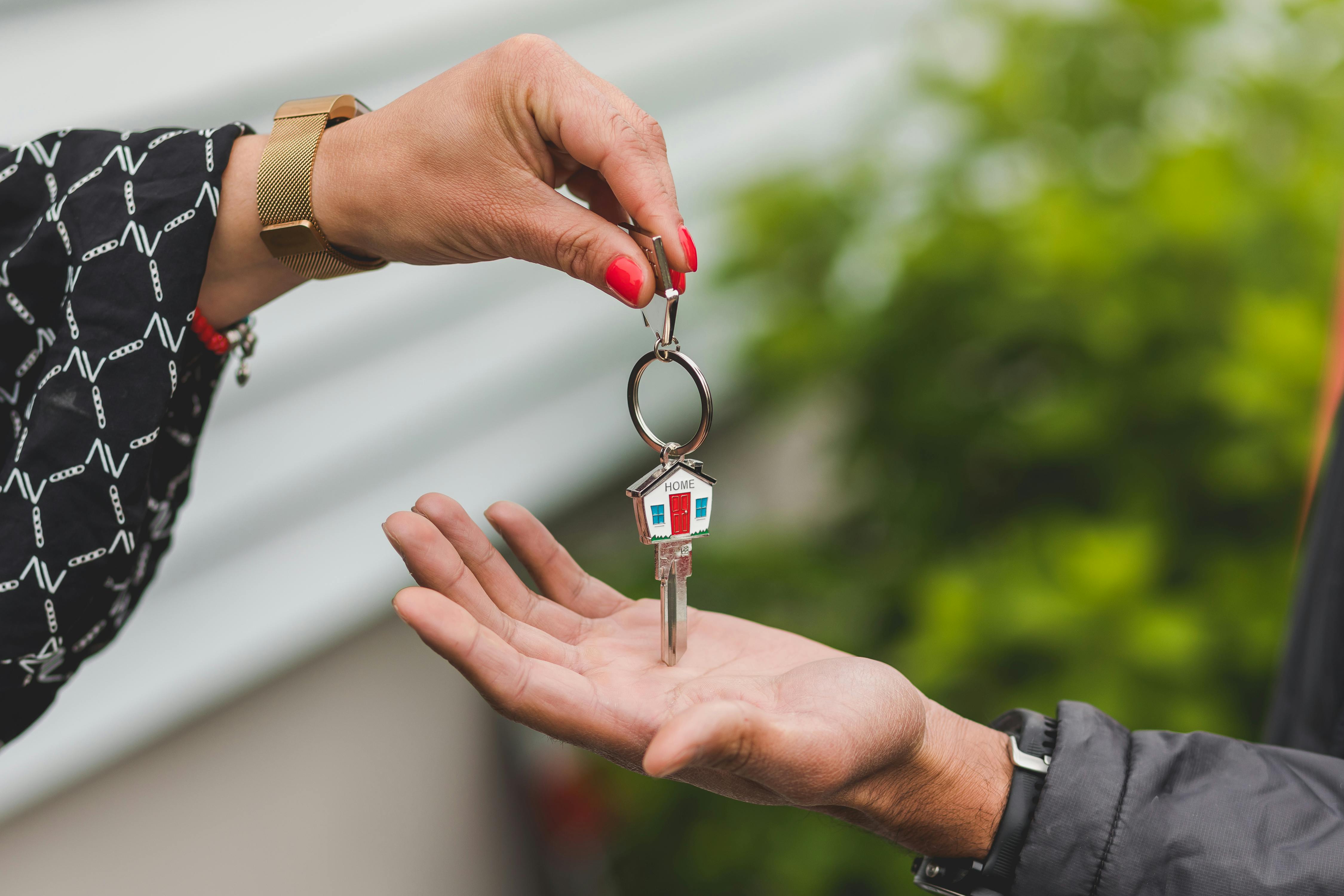 Hand handing over a key