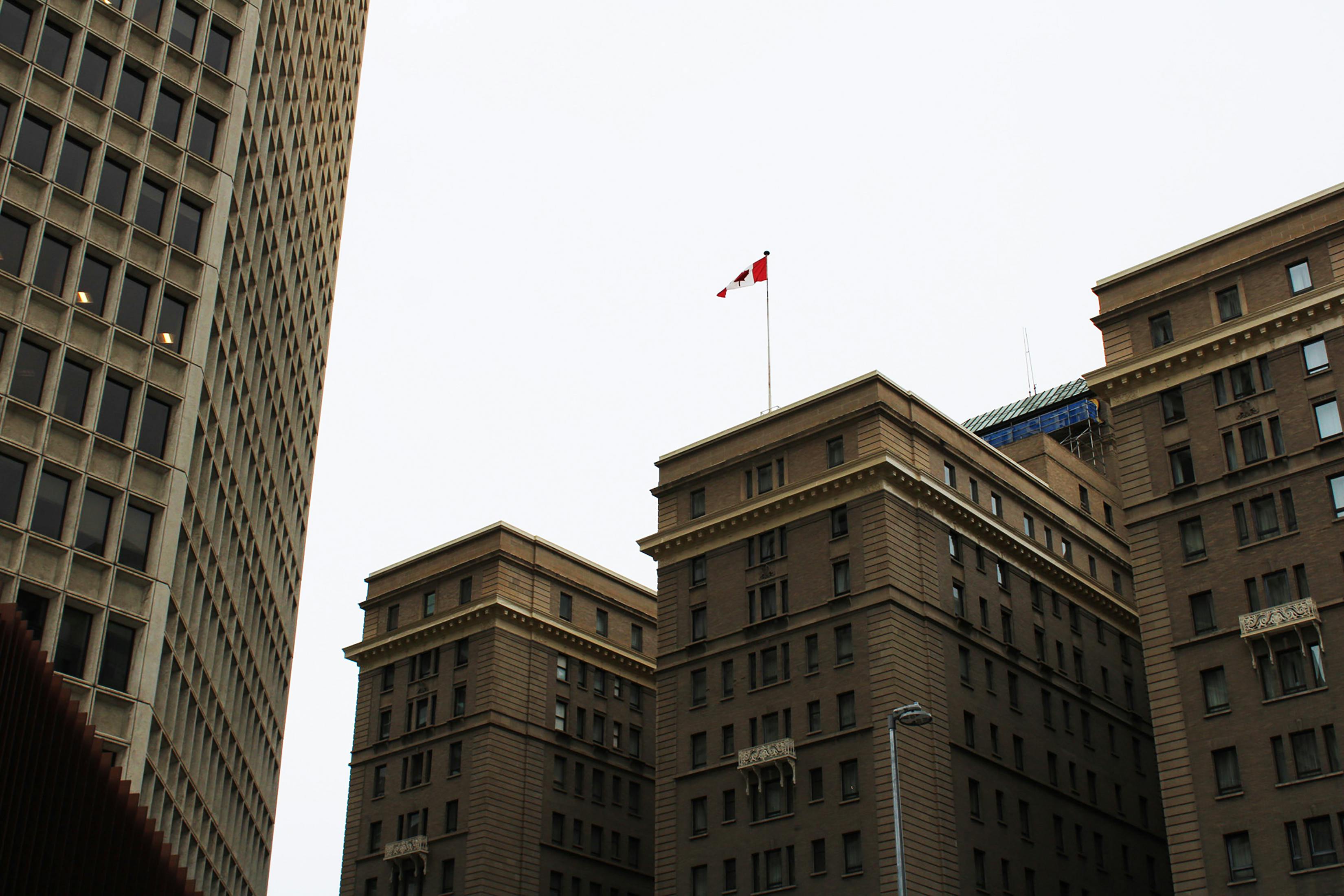 Experience a low angle urban perspective of downtown Calgary's iconic architecture under a neutral sky