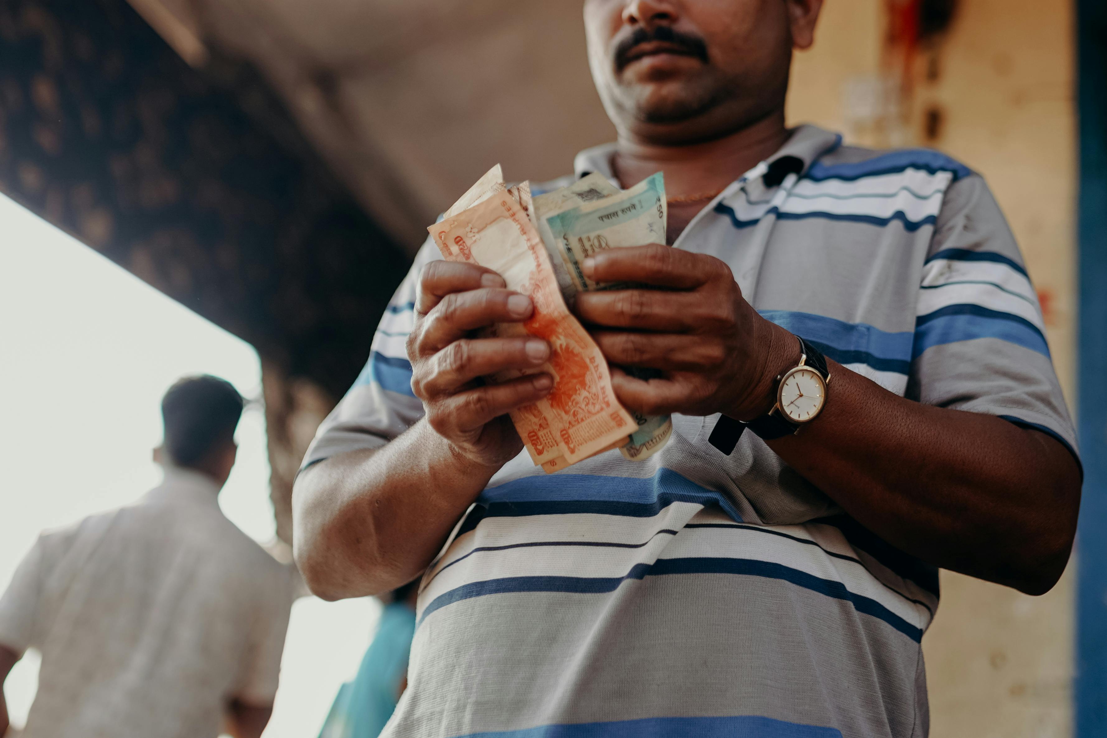 Man counting rupee notes