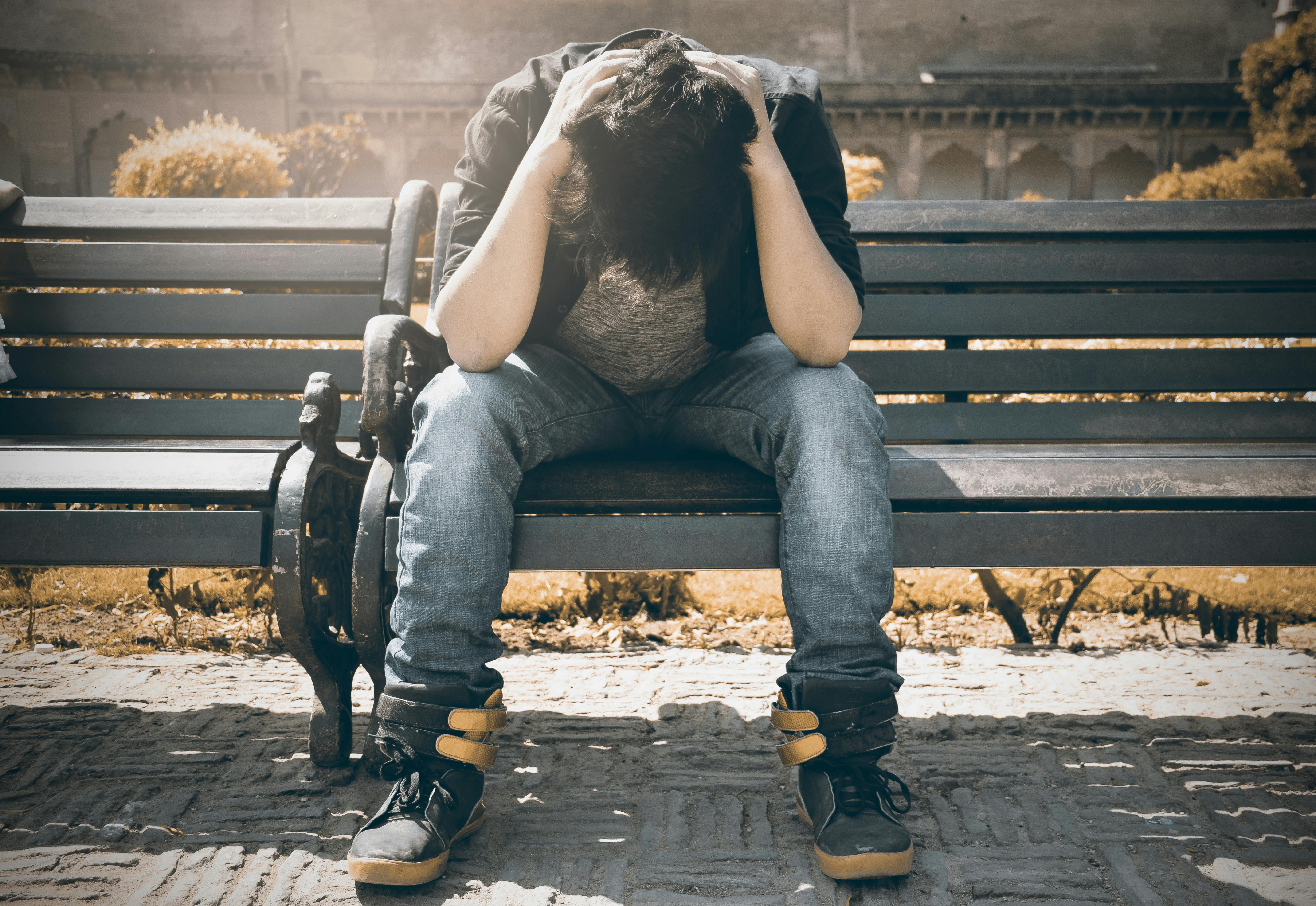 Man sitting alone on a bench