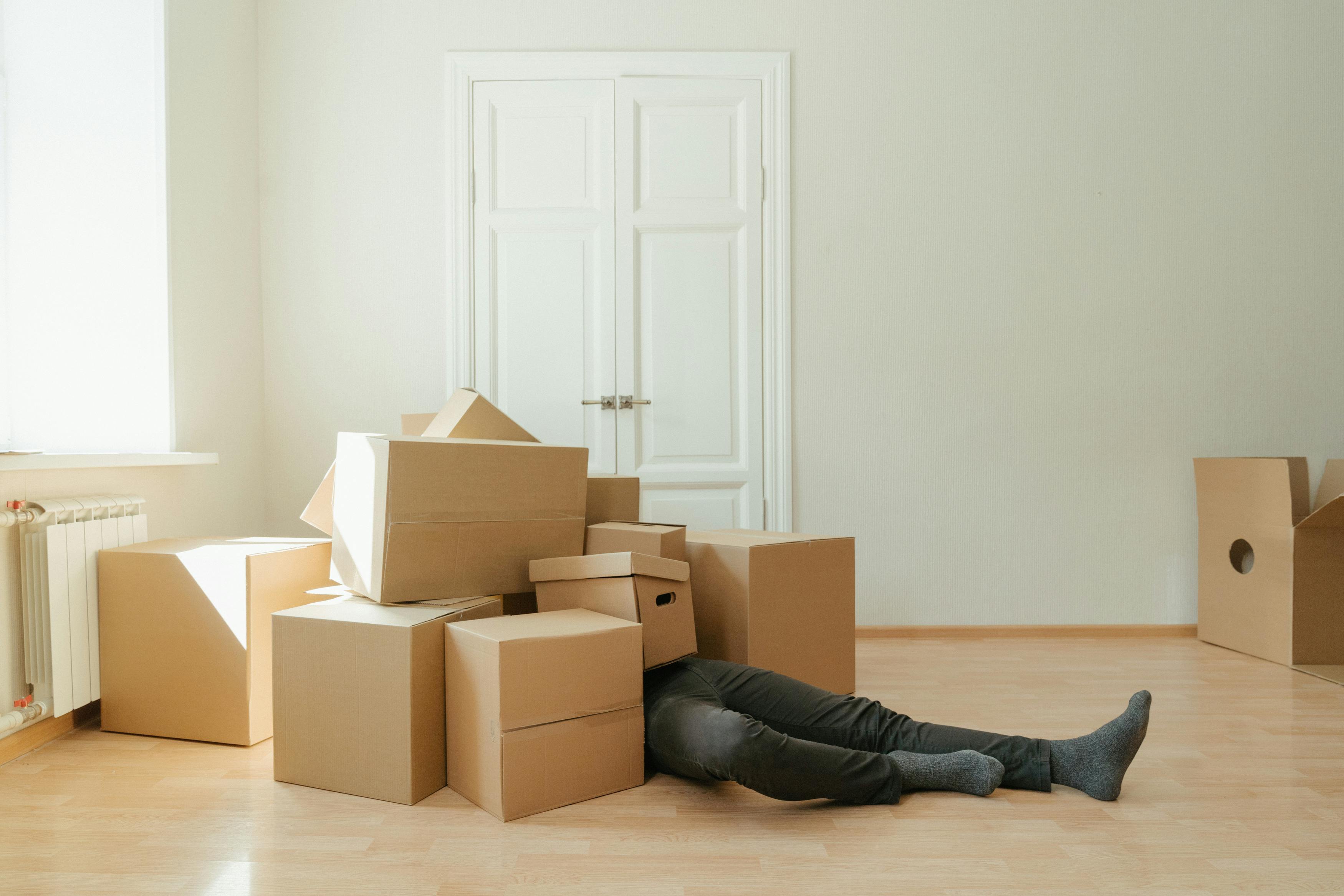 Person on floor surrounded by boxes