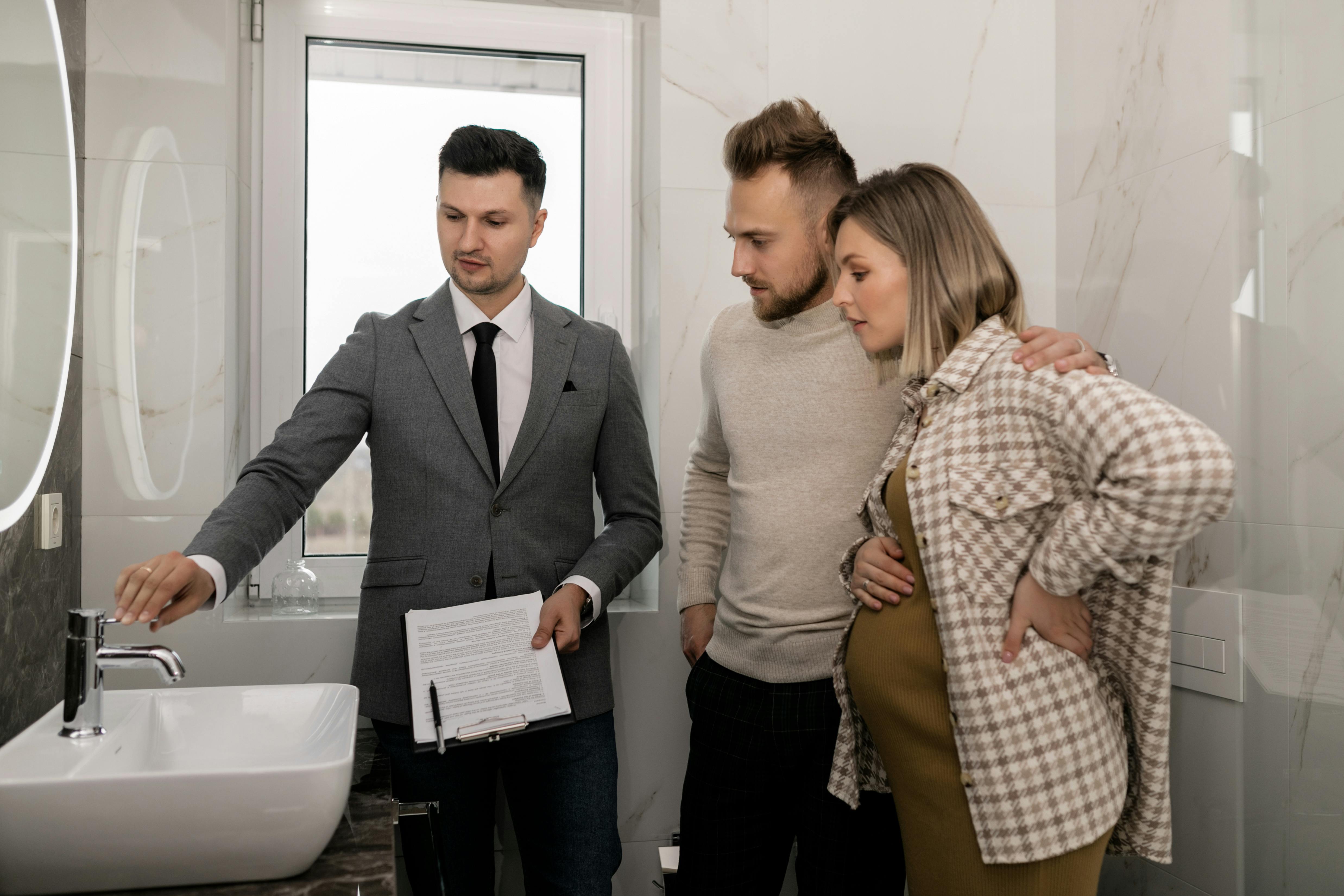 Real estate agent demonstrating bathroom features