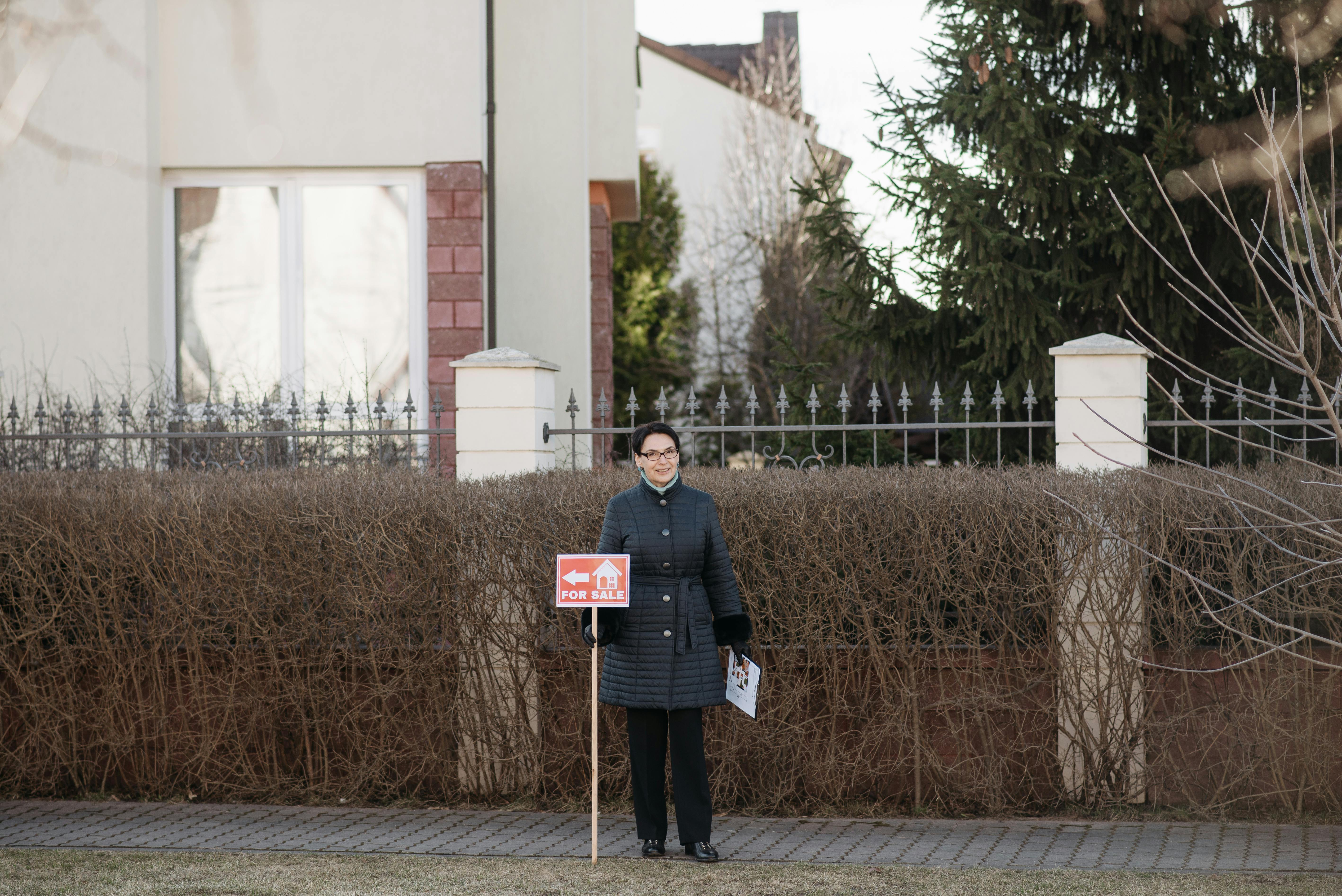 Real estate agent outside a house