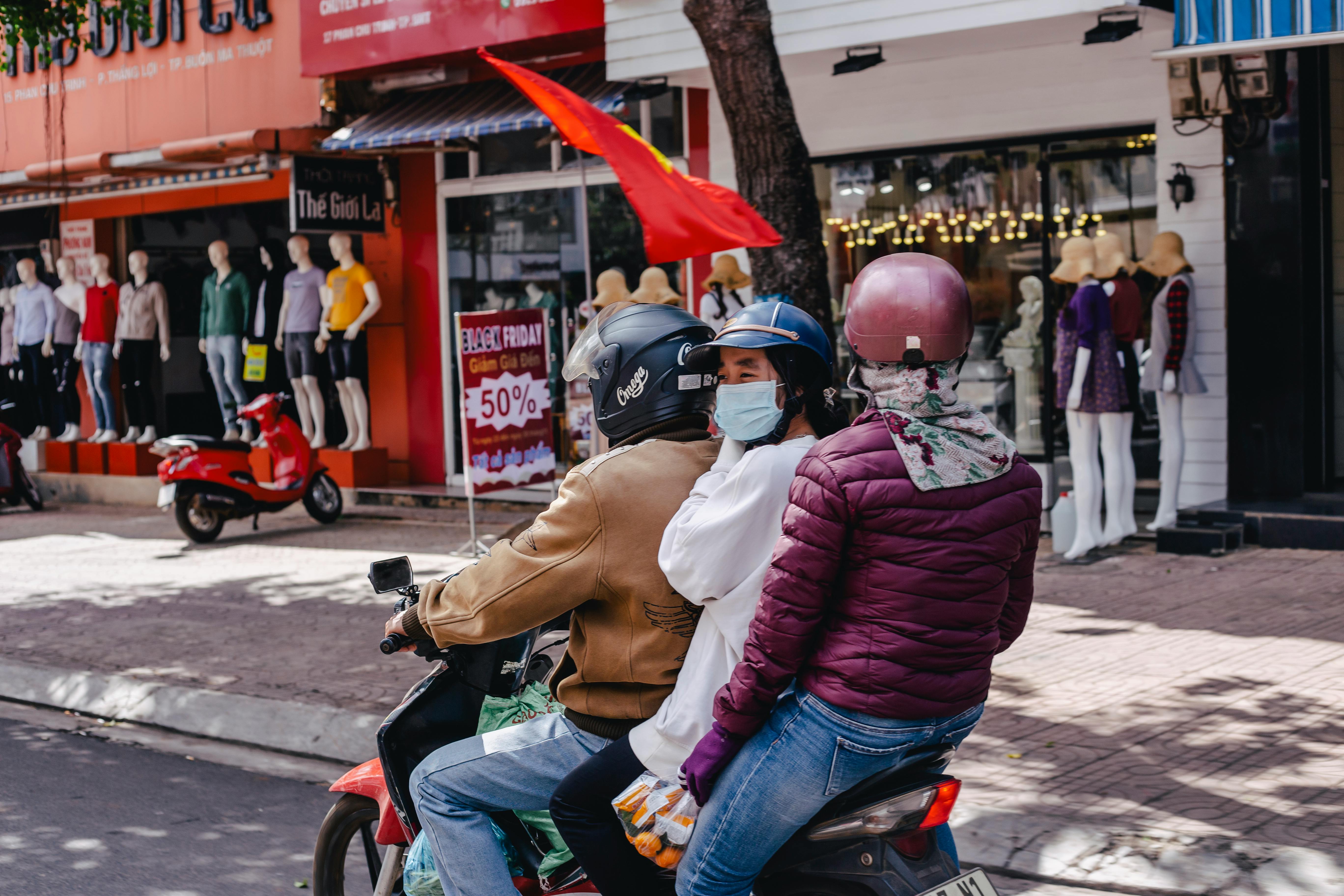 Three people on a motorcycle