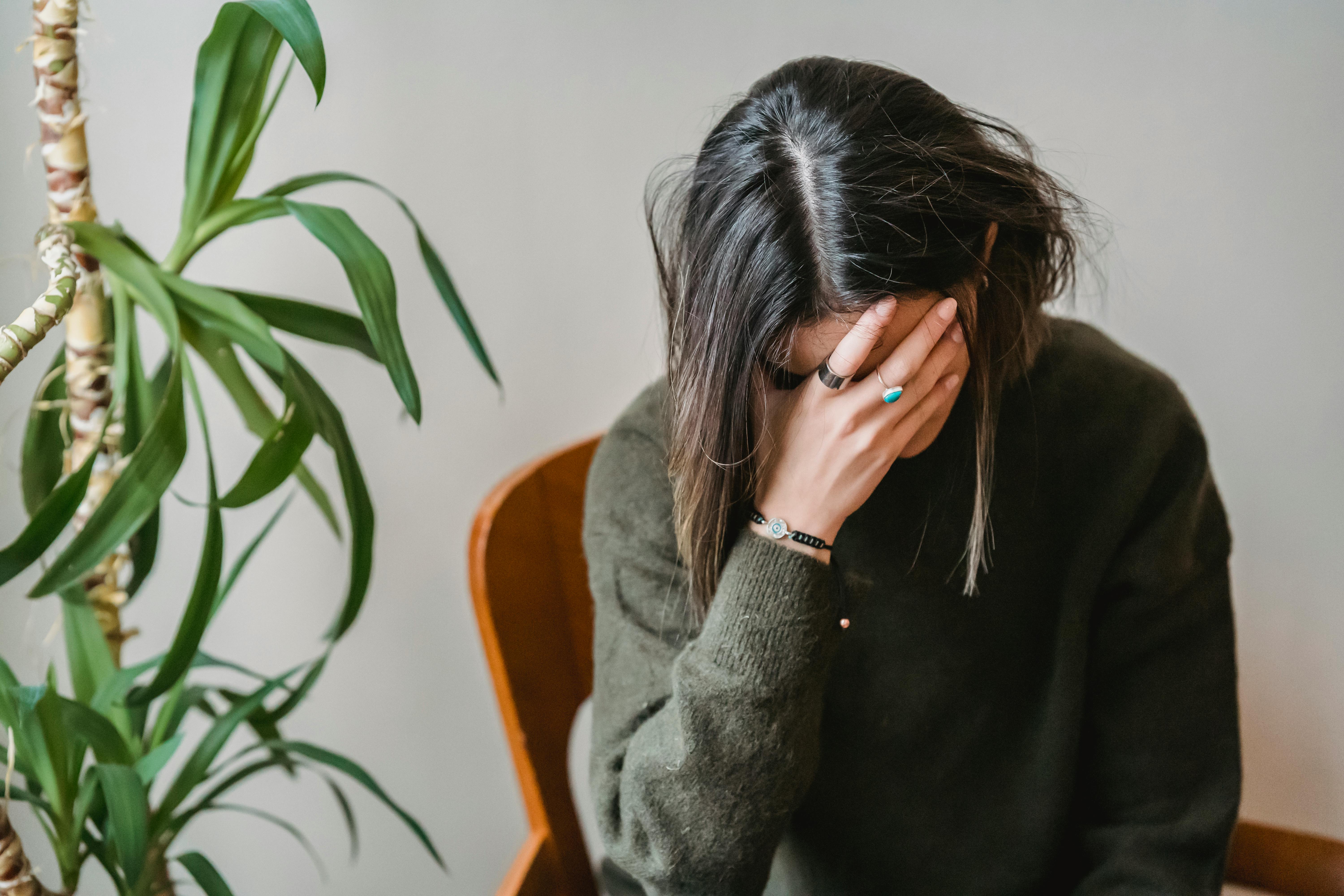 Distressed woman sitting at home